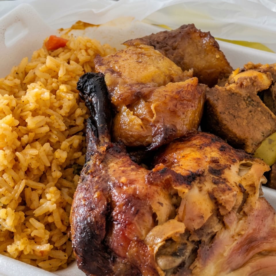 Takeout container filled with yellow seasoned rice, grilled chicken, roasted meat, and vegetables.
